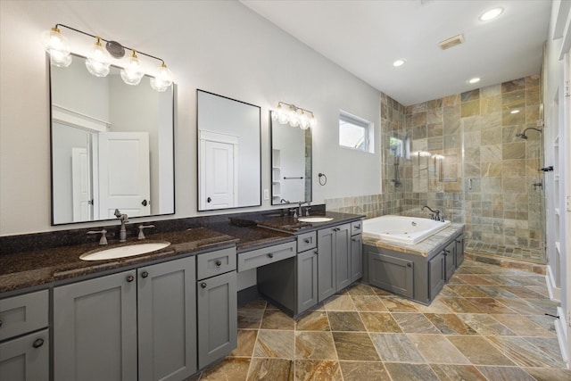 bathroom featuring vanity and shower with separate bathtub