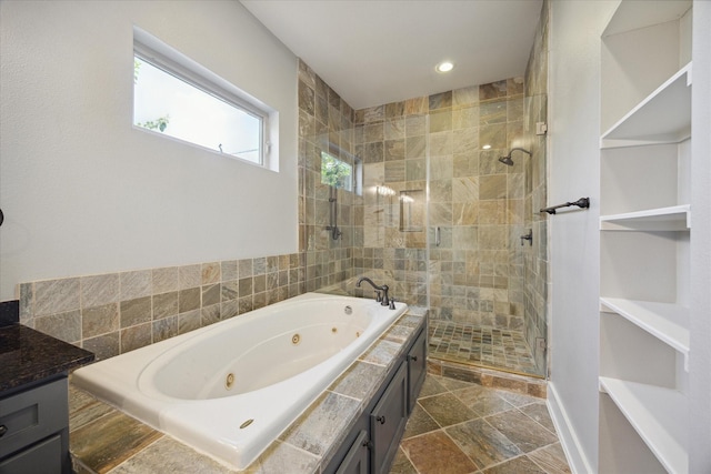 bathroom with vanity and separate shower and tub