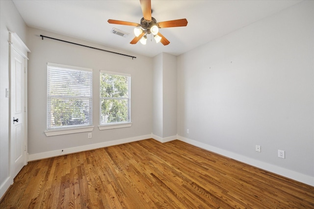 empty room with ceiling fan and wood-type flooring