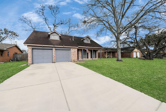 view of front of home with a garage, central AC, and a front yard