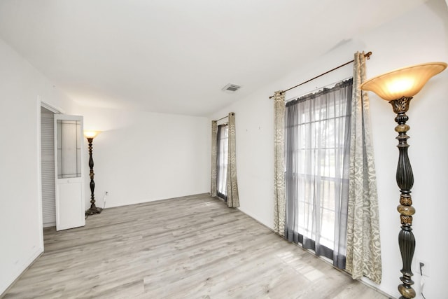 unfurnished room with light wood-type flooring