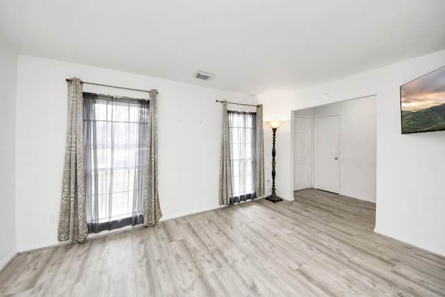 spare room with light hardwood / wood-style flooring