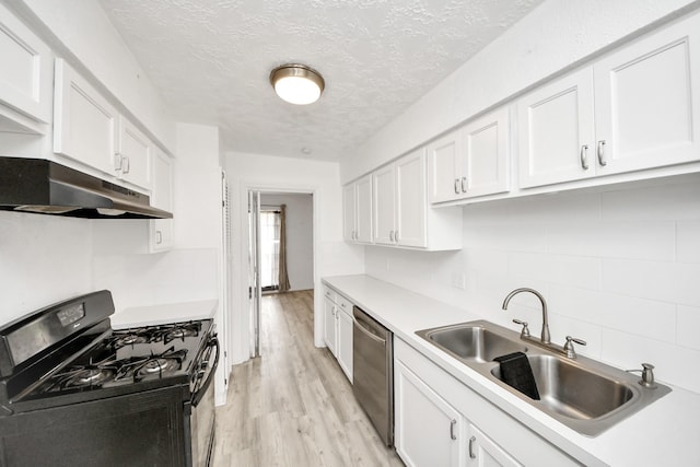 kitchen featuring white cabinetry, stainless steel dishwasher, sink, and gas stove