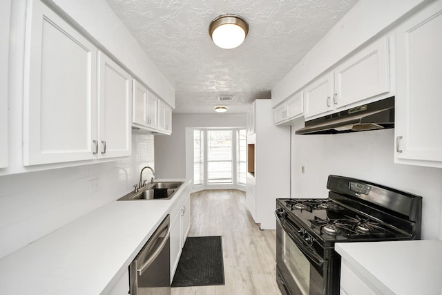 kitchen with sink, white cabinets, black range with gas stovetop, stainless steel dishwasher, and light hardwood / wood-style floors