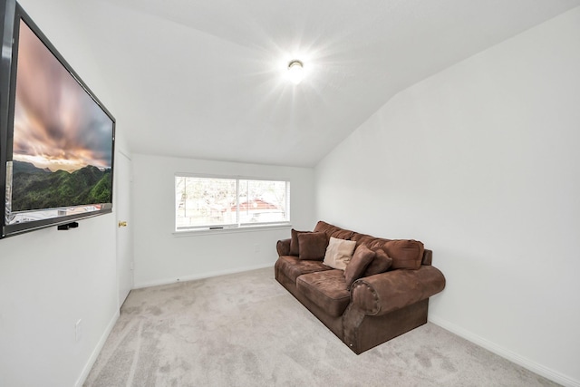 sitting room with lofted ceiling and light carpet
