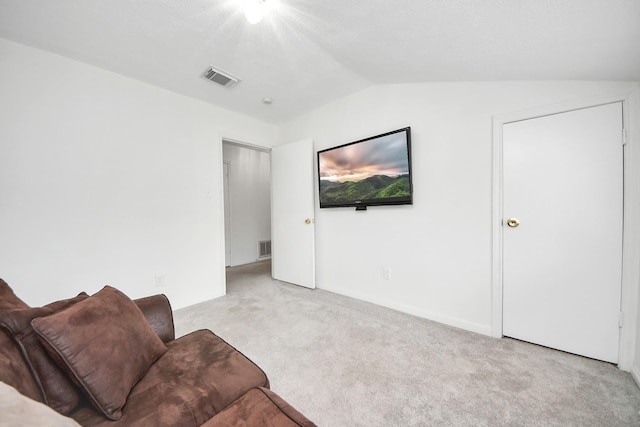 living room featuring light carpet and lofted ceiling