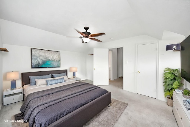 bedroom with ceiling fan, light colored carpet, and lofted ceiling