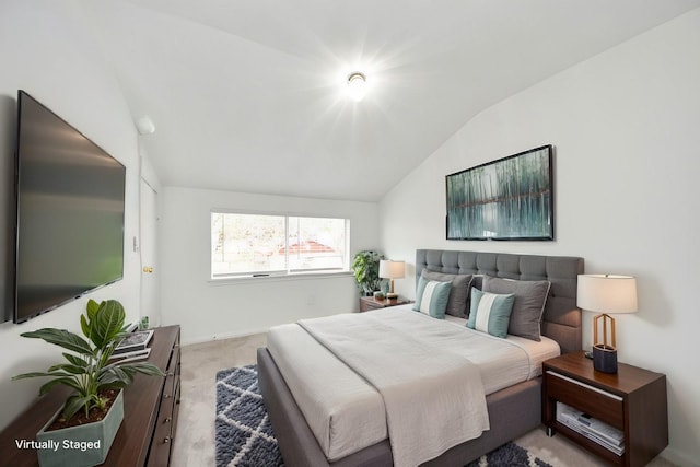 bedroom featuring lofted ceiling and light carpet
