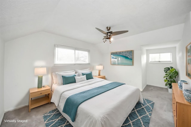 bedroom with multiple windows, light carpet, ceiling fan, and vaulted ceiling