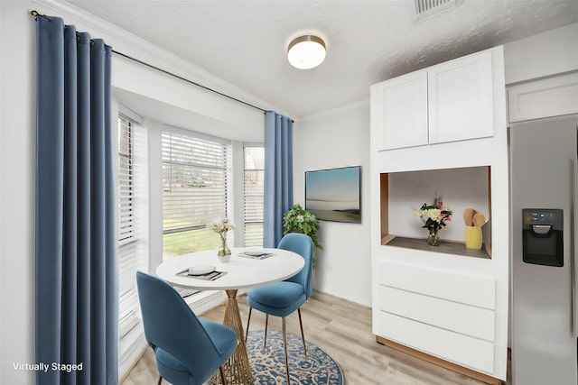 dining space with light wood-type flooring
