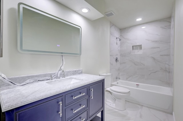 full bathroom featuring vanity, tiled shower / bath combo, and toilet