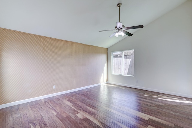 spare room featuring ceiling fan, wood-type flooring, and vaulted ceiling