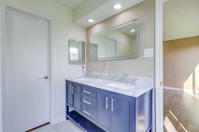 bathroom with vanity and hardwood / wood-style flooring