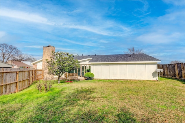 back of house featuring a yard