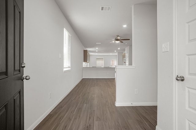 interior space with ceiling fan and dark hardwood / wood-style floors