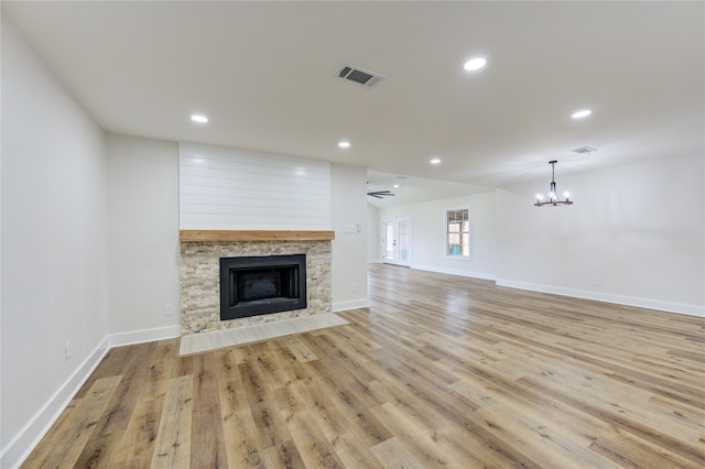 14142 Rosetta Dr, Cypress, TX 77429 - unfurnished living room with light wood-type flooring, a fireplace, a chandelier, baseboards, and recessed lighting