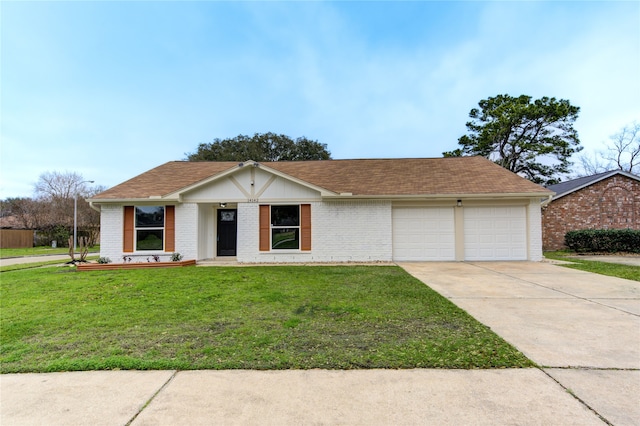 14142 Rosetta Dr, Cypress, TX 77429 - ranch-style house with an attached garage, driveway, brick siding, and a front lawn