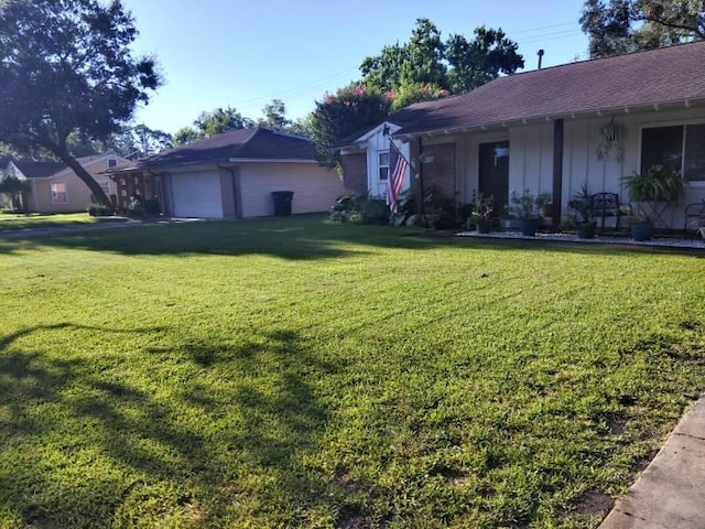 ranch-style house featuring a garage and a front lawn