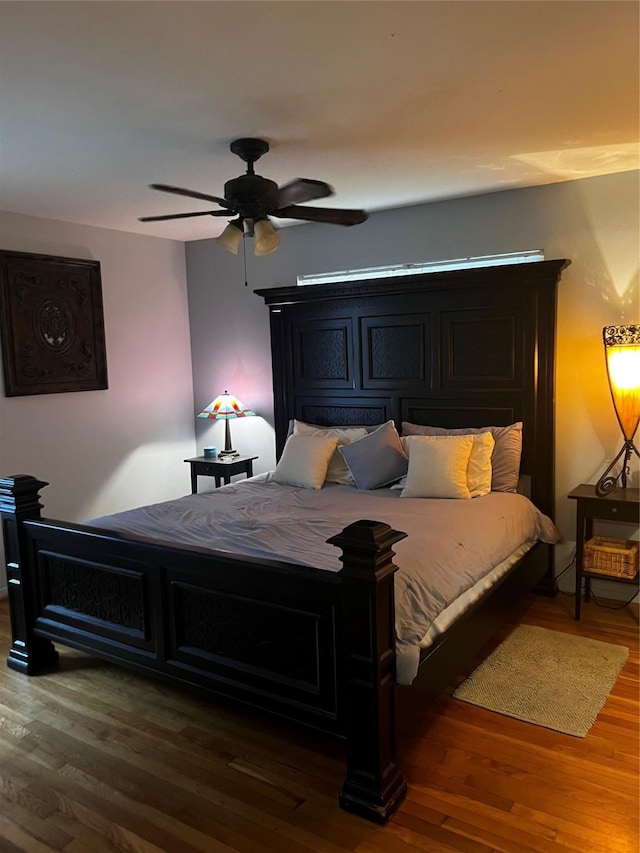 bedroom with hardwood / wood-style floors and ceiling fan