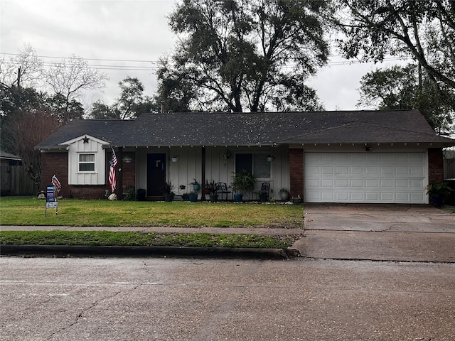 single story home featuring a garage and a front yard