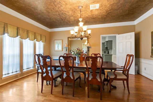 7315 Muirfield Valley Dr, Houston, TX 77095 - dining space with ornamental molding, a notable chandelier, wood finished floors, and visible vents