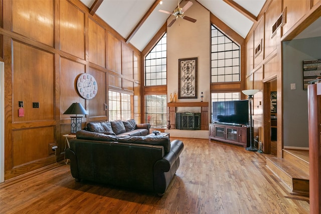 7315 Muirfield Valley Dr, Houston, TX 77095 - living area featuring a ceiling fan, high vaulted ceiling, beamed ceiling, a fireplace with raised hearth, and light wood finished floors