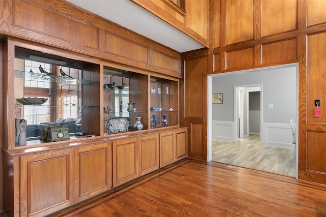 7315 Muirfield Valley Dr, Houston, TX 77095 - bar with a decorative wall, wood finished floors, and a wainscoted wall
