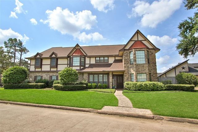 tudor home featuring a front yard