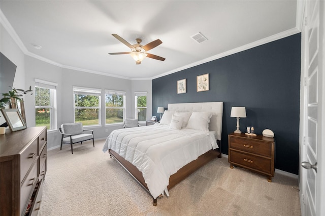 carpeted bedroom with ceiling fan and ornamental molding