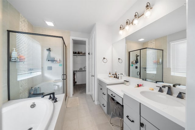 bathroom with vanity, tile patterned flooring, and plus walk in shower