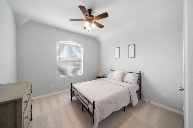 carpeted bedroom featuring vaulted ceiling and ceiling fan