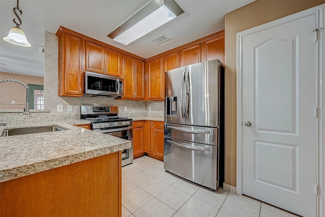 403 Crosby Village Dr, Crosby, TX 77532 - kitchen featuring light tile patterned flooring, sink, decorative light fixtures, appliances with stainless steel finishes, and backsplash