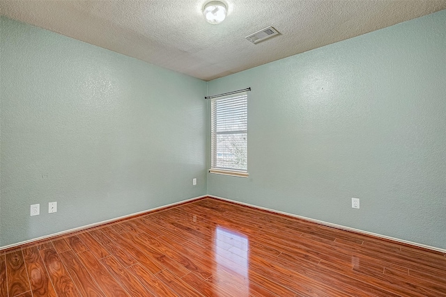 403 Crosby Village Dr, Crosby, TX 77532 - spare room featuring hardwood / wood-style floors and a textured ceiling