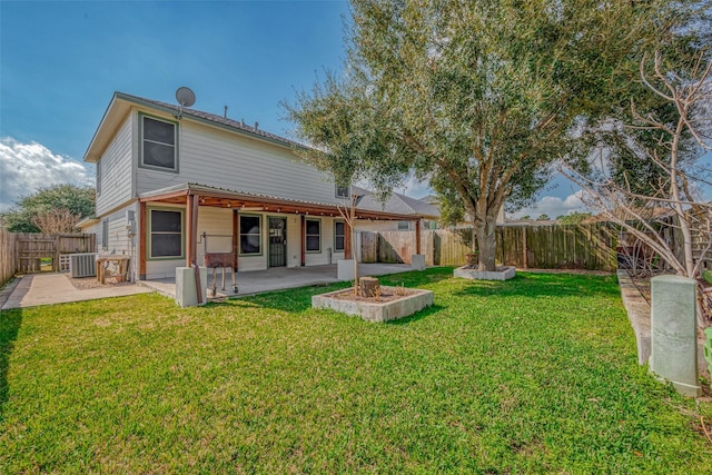 rear view of house featuring cooling unit, a lawn, and a patio