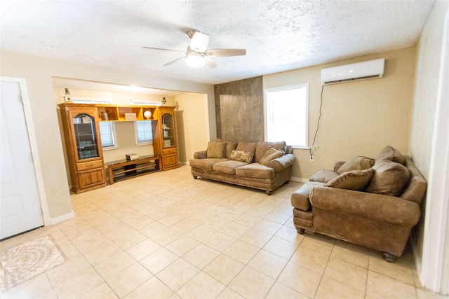 living room featuring ceiling fan, a wall mounted air conditioner, a textured ceiling, and light tile patterned floors