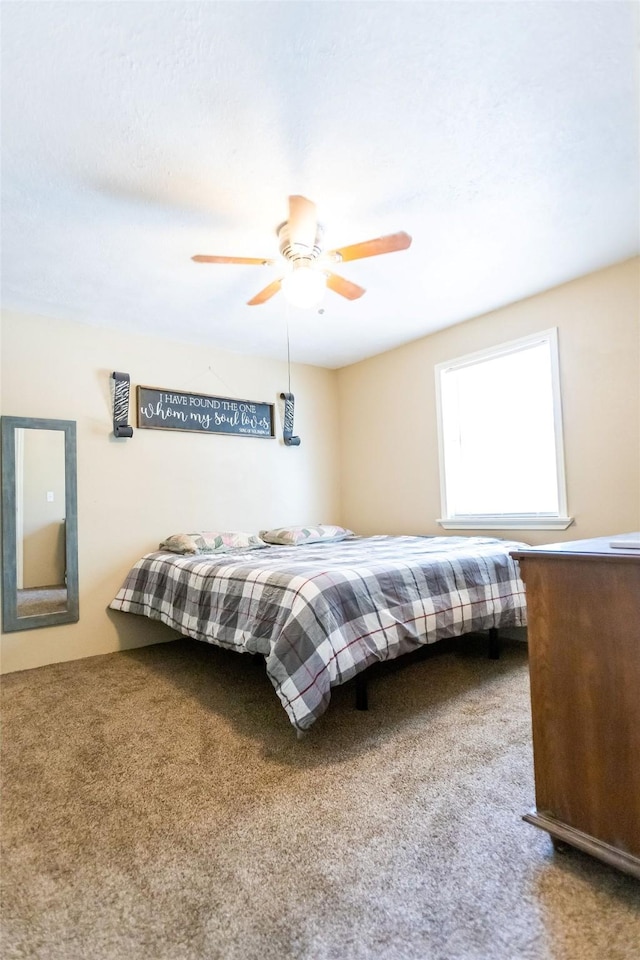 carpeted bedroom featuring ceiling fan