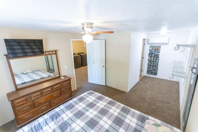 bedroom with ceiling fan, a wall mounted air conditioner, washer and clothes dryer, and dark carpet