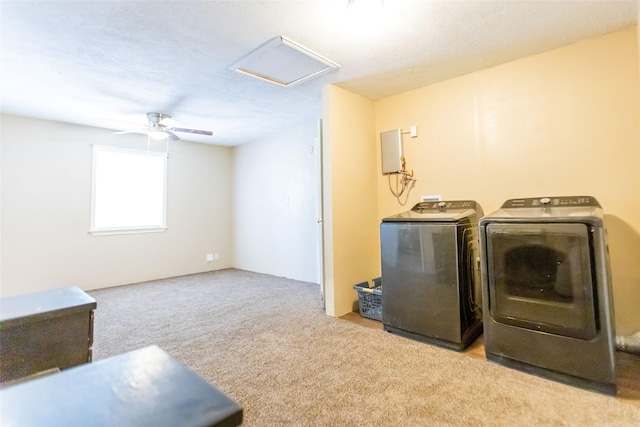 laundry room featuring ceiling fan, washer and clothes dryer, and light carpet