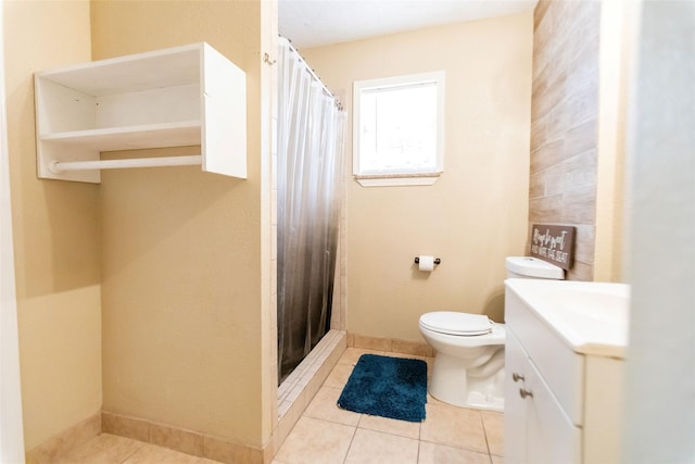 bathroom featuring tile patterned flooring, vanity, curtained shower, and toilet