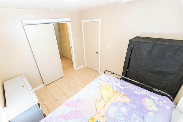 bedroom with a closet and light tile patterned floors