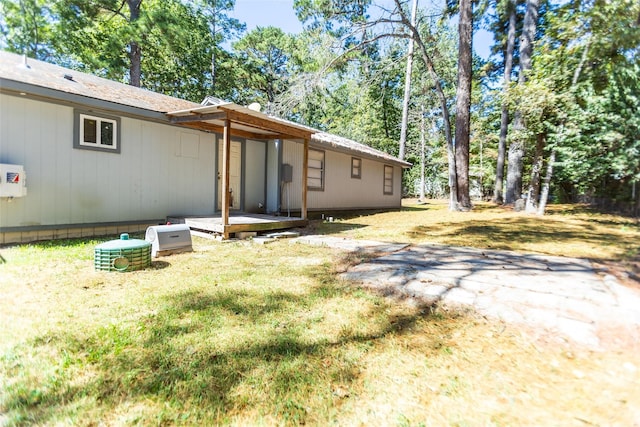 back of property featuring a lawn