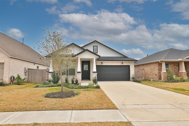 view of front of home with a garage, concrete driveway, and a front yard