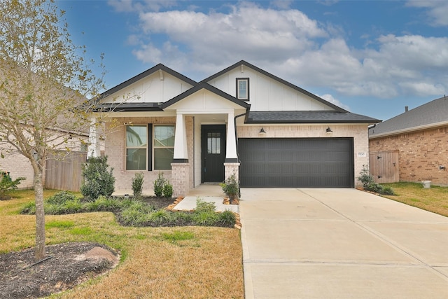 view of front of house with an attached garage, brick siding, fence, driveway, and a front lawn