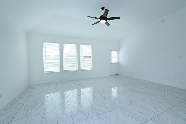 unfurnished room with ceiling fan and vaulted ceiling