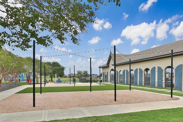 view of property's community featuring playground community and a lawn