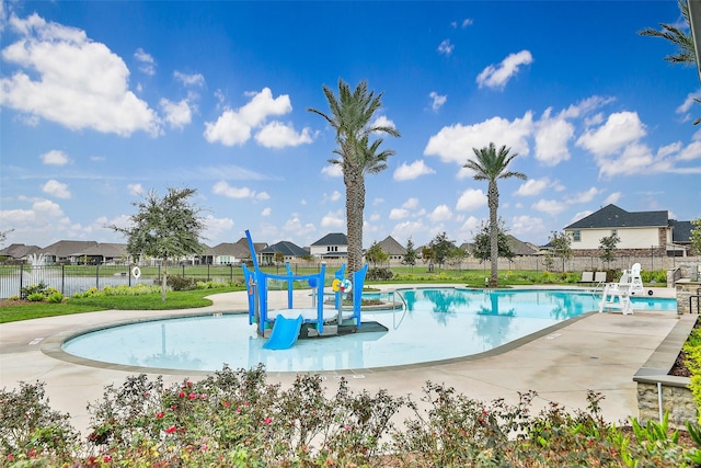 community pool with fence and a residential view