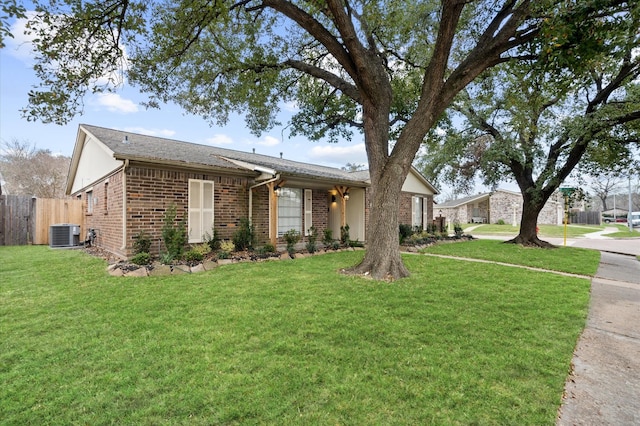 ranch-style house featuring central AC unit and a front yard