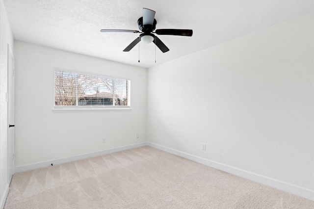 carpeted spare room featuring ceiling fan and a textured ceiling