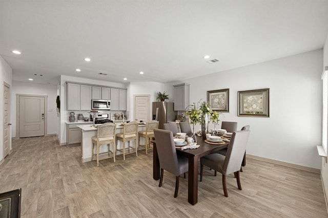 dining space featuring light wood-type flooring