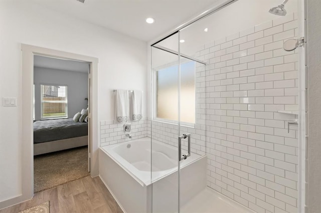 bathroom with hardwood / wood-style flooring and plus walk in shower